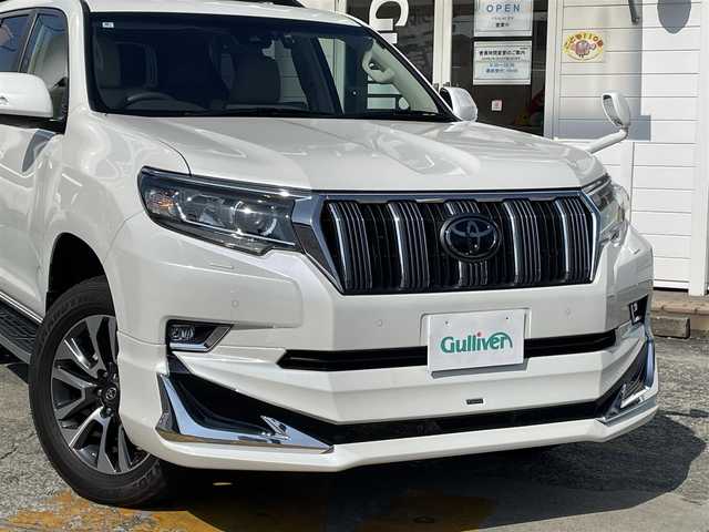 トヨタ ランドクルーザー プラド TX Lパッケージ 神奈川県 2022(令4)年 2.3万km ホワイトパールクリスタルシャイン アルパインメモリナビ　/　（CD・DVD・Bluetooth・HDMI）/フルセグTV/電動ムーンルーフ/モデリスタフロントスポイラー/モデリスタリヤスカート/ベージュレザーシート/シートヒーター/エアシート/トヨタセーフティセンス/レーダークルーズコントロール/ルーフレール/純正OP19インチAW/LEDヘッドライト/LEDフォグライト/バックカメラ/前席パワーシート/クリアランスソナー/スマートキー×2/保証書/取扱説明書