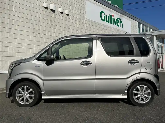 スズキ ワゴンＲ スティングレー HYBRID X 山形県 2021(令3)年 1.4万km スチールシルバーM 禁煙車/4WD/社外オーディオ/・AM/FM/CD/AUX/アイドリングストップ/コーナーセンサー/衝突被害軽減ブレーキ/車線逸脱警報/横滑り防止装置/盗難防止装置/LEDヘッドライト/オートライト/フロントフォグランプ/シートヒーター（D/N席）/フロアマット/冬タイヤ積み込み/保証書/取扱説明書