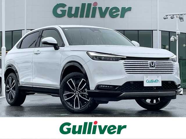 ホンダ ヴェゼル ハイブリッド e:HEV Z 佐賀県 2025(令7)年 0.1万km未満 プラチナホワイトパール 登録時走行距離5km/登録済未使用車/9型 Honda CONNECTディスプレ－オーディオ/・AppleCarPlay AndroidAuto/・Bluetooth フルセグTV USB/バックカメラ/ETC2.0/パワーバックドア/革巻きステアリング/ステアリングリモコン/ステアリングヒーター/シートヒーター/純正LEDヘッドライト/アダプティブドライビングビーム/MTモード付AT/電子パーキングブレーキ/オートブレーキホールド/純正18インチアルミホイール/スマートキー/スペアキー１本/HondaSENSING/・衝突軽減ブレーキ/・誤発信抑制機能/・車線維持支援システム/・先行車発進お知らせ機能/・路外逸脱抑制機能/・トラフィックジャムアシスト/・渋滞追従機能付きアダプティブクルーズコントロール/・ブラインドスポットインフォメーション