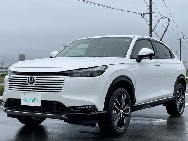 ホンダ ヴェゼル ハイブリッド e:HEV Z 佐賀県 2025(令7)年 0.1万km未満 プラチナホワイトパール 登録時走行距離5km/登録済未使用車/9型 Honda CONNECTディスプレ－オーディオ/・AppleCarPlay AndroidAuto/・Bluetooth フルセグTV USB/バックカメラ/ETC2.0/パワーバックドア/革巻きステアリング/ステアリングリモコン/ステアリングヒーター/シートヒーター/純正LEDヘッドライト/アダプティブドライビングビーム/MTモード付AT/電子パーキングブレーキ/オートブレーキホールド/純正18インチアルミホイール/スマートキー/スペアキー１本/HondaSENSING/・衝突軽減ブレーキ/・誤発信抑制機能/・車線維持支援システム/・先行車発進お知らせ機能/・路外逸脱抑制機能/・トラフィックジャムアシスト/・渋滞追従機能付きアダプティブクルーズコントロール/・ブラインドスポットインフォメーション