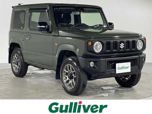 スズキ ジムニー XC 福岡県 2022(令4)年 3.1万km ジャングルグリーン ・社外ナビ/・フルセグTV/・ドアバイザー/・フロアマット/・シートヒーター/・革巻きステアリング/・ステアリングスイッチ/・オートライト/・アイドリングストップ/・スマートキー/・プッシュスタート/・ミラーヒーター