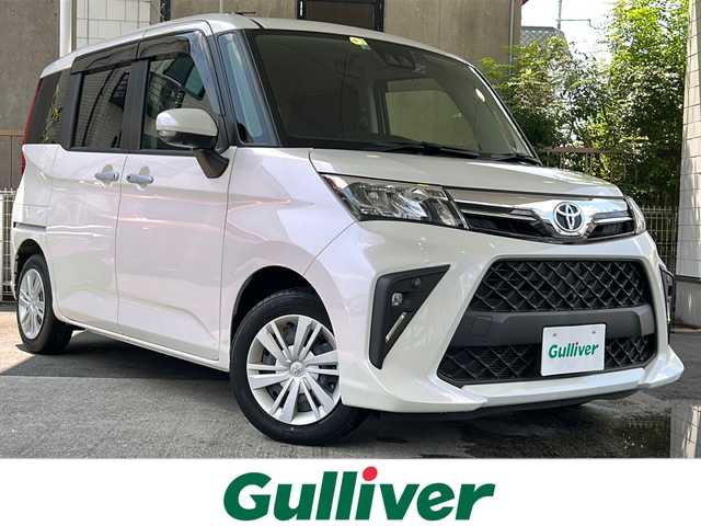 トヨタ ルーミー G 京都府 2022(令4)年 0.2万km パールホワイトⅢ ワンオーナー車/純正SDナビ/・Bluetooth Audio/・CD/・ワンセグTV/・USB/バックカメラ/パノラミックビューモニター/アイドリングストップ/前後ドライブレコーダー/スマートアシスト/・衝突警報機能/・衝突回避支援ブレーキ機能/・ブレーキ制御付誤発進抑制機能/・車線逸脱警報機能/・路側逸脱警報機能/・ふらつき警報/・先行車発進お知らせ機能/・クリアランスソナー/・AHB/・ADB/シートヒーター(D＋N席)/両側パワースライドドア/ステアリングスイッチ/電動格納ウィンカーミラー/リアサンシェード/オートリトラクタブルミラー/純正フロアマット/純正ドアバイザー/取扱説明書/ナビ取扱説明書/保証書/スマートキースペア