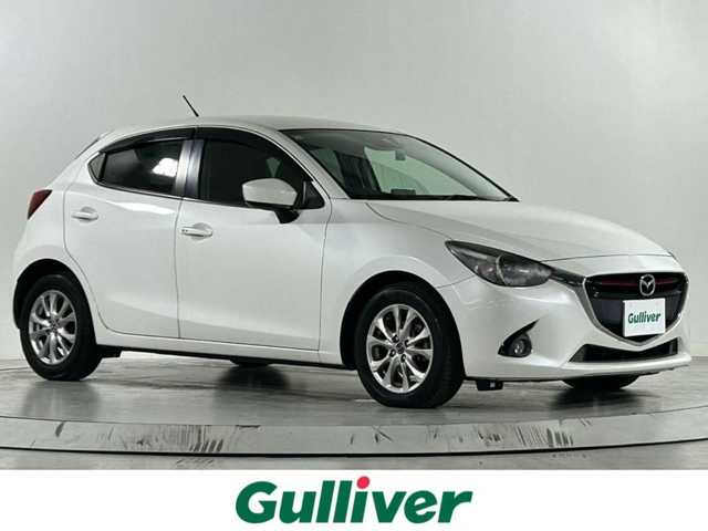 マツダ デミオ XD 佐賀県 2015(平27)年 9.9万km スノーフレイクホワイトパールマイカ 純正７型ナビ/（フルセグTV/CD/DVD/Bluetooth/USB/AM/FM）/衝突軽減システム/バックカメラ/クルーズコントロール/前後ドライブレコーダー/純正15インチアルミホイール/純正フロアマット/ＬＥＤヘッドライト/オートライト/フォグライト/ＭＴ付ＡＴ/ビルトインＥＴＣ/スマートキー/スペアキー×１/ドアバイザー/アイソフィックス/横滑り防止装置/アイドリングストップ