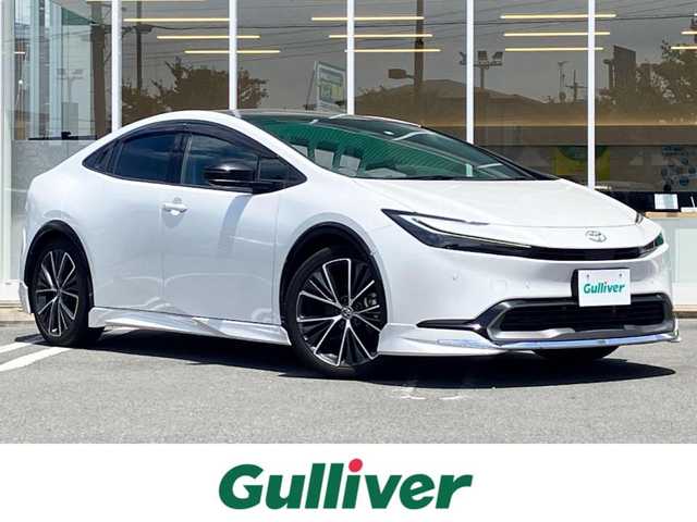 トヨタ プリウス Z 熊本県 2023(令5)年 3.7万km プラチナホワイトパールマイカ エンジンスタートボタン/パワーステアリング/パワーウィンドウ/ワンオーナー/保証書/取扱説明書/１００V充電/パーキングアシスト/アイドリングストップ/スマートキー/スペアキー１本/オートエアコン/クルーズコントロール/USB入力端子/ETC2.0/全方位カメラ/純正12.3インチナビ（BT/フルセグ）/ツインガラスルーフ/電動リアゲート/純正フロアマット/純正アルミホイール/D席パワーシート/D席N席シートヒーター/D席N席エアシート/モデリスタフルエアロ/ABS/横滑り防止装置/コーナーセンサー前後/レーンキープアシスト/オートライト/オートマチックハイビーム/LEDヘッドライト/W＋サイドエアバック/衝突軽減システム/ステアリングヒーター/ワイヤレス充電/BSM/デジタルインナーミラー/トランクトレイ