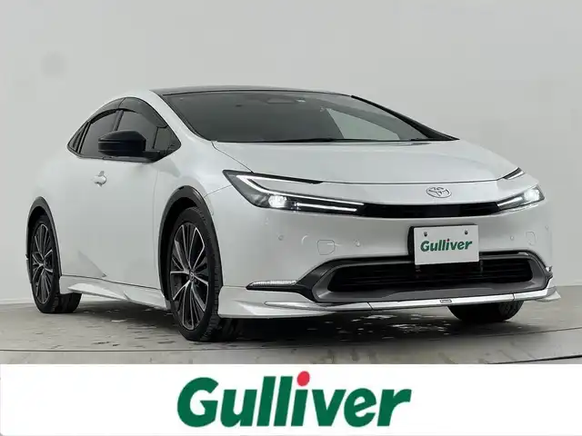 トヨタ プリウス Z 熊本県 2023(令5)年 3.7万km プラチナホワイトパールマイカ エンジンスタートボタン/パワーステアリング/パワーウィンドウ/ワンオーナー/保証書/取扱説明書/１００V充電/パーキングアシスト/アイドリングストップ/スマートキー/スペアキー１本/オートエアコン/クルーズコントロール/USB入力端子/ETC2.0/全方位カメラ/純正12.3インチナビ（BT/フルセグ）/ツインガラスルーフ/電動リアゲート/純正フロアマット/純正アルミホイール/D席パワーシート/D席N席シートヒーター/D席N席エアシート/モデリスタフルエアロ/ABS/横滑り防止装置/コーナーセンサー前後/レーンキープアシスト/オートライト/オートマチックハイビーム/LEDヘッドライト/W＋サイドエアバック/衝突軽減システム/ステアリングヒーター/ワイヤレス充電/BSM/デジタルインナーミラー/トランクトレイ