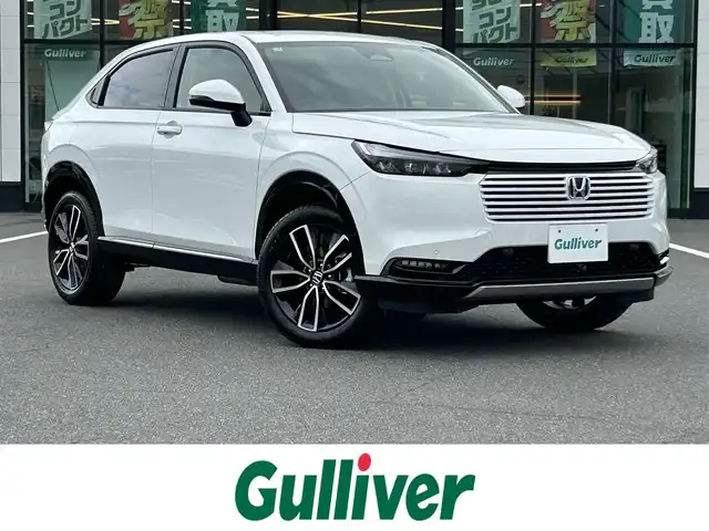 ホンダ ヴェゼル ハイブリッド e:HEV Z 岡山県 2025(令7)年 0.1千km プラチナホワイトパール 登録時走行距離3km/登録済未使用車/純正9インチナビ/フルセグTV(AM.FM.TV.BT)/バックカメラ/ビルトインETC2.0/ブラインドスポットモニター/シートヒーター/ステアリングヒーター/クリアランスソナー/衝突軽減ブレーキ/レーダークルーズコントロール/レーンキープアシスト/ダウンヒルアシストコントロール/横滑り防止装置/オートライト/アイドリングストップ/パワーバックドア/ワイヤレス充電/18インチ純正AW