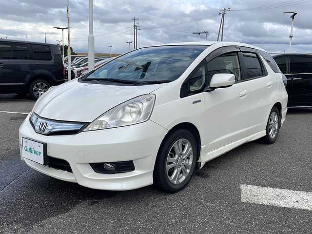 ホンダ フィット シャトル ハイブリッド スマートセレファインライン 新潟県 2013(平25)年 7.9万km プレミアムホワイト 純正メモリナビ/(AM/FM/CD/DVD/ワンセグTV)/スタッドレスタイヤ/ハーフレザーシート/シートヒーター/クルーズコントロール/夏タイヤ積載/ABS/横滑り防止装置/盗難防止装置/Modulo15インチアルミホイール/純正フロアマット