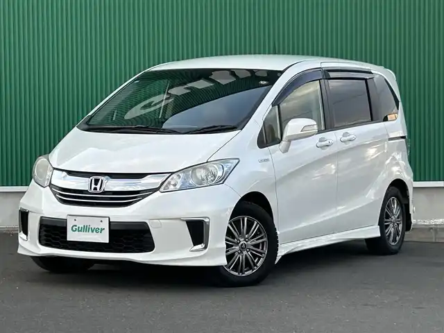 ホンダ フリード ハイブリット ジャストセレクション 宮城県 2014(平26)年 12.7万km プラチナムホワイトパール 純正ナビ/(フルセグTV/CD/DVD/SD/BT)/バックカメラ/フリップダウンモニター/ビルトインETC/クルーズコントロール/レザー調シートカバー/オートエアコン/革巻きステアリング/ステアリングスイッチ/両側パワースライドドア/スマートキー/スペアキー/ウインカー付き電動格納ミラー/ドアバイザー/HIDヘッドライト/純正フロアマット/社外15インチAW