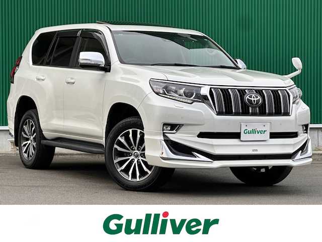 トヨタ ランドクルーザー プラド TX Lパッケージ 鹿児島県 2019(令1)年 4.4万km ホワイトパールクリスタルシャイン サンルーフ/モデリスタエアロ（F/R）/セーフティセンス/・プリクラッシュセーフティ/・レーダークルーズコントロール/・レーンディパーチャーアラート/・オートマチックハイビーム/前後コーナーセンサー/純正9インチナビ（NSZT-Y68T）/・CD/DVD/・Bluetooth/・フルセグTV/バックカメラ/ビルトインETC/本革シート/前席パワーシート/前席シートヒーター/ベンチレーション/革巻きステアリング/ステアリングスイッチ/MTモード付きAT/LEDヘッドライト/フォグライト/オートライト/サイドステップ/スマートキー＆プッシュスタート/ウィンカーミラー/純正19インチAW/純正フロアマット/ドアバイザー/新車保証書/取扱説明書/W/サイド/カーテンエアバッグ