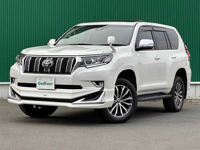 トヨタ ランドクルーザー プラド TX Lパッケージ 鹿児島県 2019(令1)年 4.4万km ホワイトパールクリスタルシャイン サンルーフ/モデリスタエアロ（F/R）/セーフティセンス/・プリクラッシュセーフティ/・レーダークルーズコントロール/・レーンディパーチャーアラート/・オートマチックハイビーム/前後コーナーセンサー/純正9インチナビ（NSZT-Y68T）/・CD/DVD/・Bluetooth/・フルセグTV/バックカメラ/ビルトインETC/本革シート/前席パワーシート/前席シートヒーター/ベンチレーション/革巻きステアリング/ステアリングスイッチ/MTモード付きAT/LEDヘッドライト/フォグライト/オートライト/サイドステップ/スマートキー＆プッシュスタート/ウィンカーミラー/純正19インチAW/純正フロアマット/ドアバイザー/新車保証書/取扱説明書/W/サイド/カーテンエアバッグ