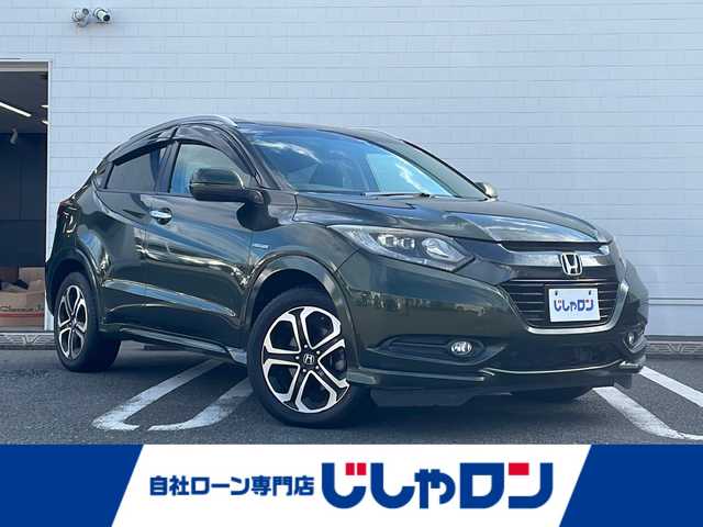 ホンダ ヴェゼル ハイブリッド Z 熊本県 2015(平27)年 9万km ミスティックグリーンパール (株)IDOMが運営する【じしゃロン熊本店】の自社ローン対象車両になります。こちらは現金ご利用時の価格です。自社ローンご希望の方は別途その旨お申付け下さい。/純正ナビ（ＣＤ　ＤＶＤ　フルセグＴＶ　ＢＴ）　/バックカメラ　/クルーズコントロール　/ビルトインＥＴＣ　/ジャズブラウン内装　/シートヒーター　/Ｗ＋サイドエアバッグ　/カーテンエアバッグ　/ルーフレール