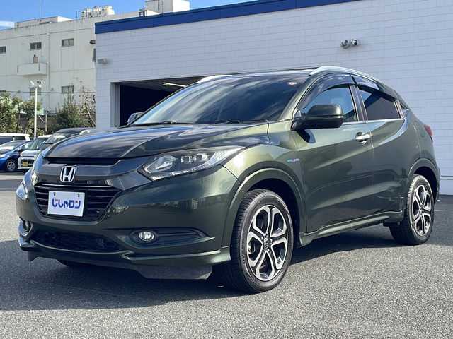 ホンダ ヴェゼル ハイブリッド Z 熊本県 2015(平27)年 9万km ミスティックグリーンパール (株)IDOMが運営する【じしゃロン熊本店】の自社ローン対象車両になります。こちらは現金ご利用時の価格です。自社ローンご希望の方は別途その旨お申付け下さい。/純正ナビ（ＣＤ　ＤＶＤ　フルセグＴＶ　ＢＴ）　/バックカメラ　/クルーズコントロール　/ビルトインＥＴＣ　/ジャズブラウン内装　/シートヒーター　/Ｗ＋サイドエアバッグ　/カーテンエアバッグ　/ルーフレール