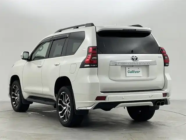 トヨタ ランドクルーザー プラド TX Lパッケージ 群馬県 2023(令5)年 4.5万km ホワイトパールクリスタルシャイン モデリスタエアロ/チルト＆スライド電動ムーンルーフ（挟み込み防止機能付）/ルーフレール/ブラインドスポットモニター［BSM］＋リヤクロストラフィックアラート /9型ワイドディスプレイオーディオ＋T-Connectナビキット/・USB(動画・音声再生/給電）/Bluetooth(ハンズフリー/オーディオ）/Miracast /マルチテレインモニター〈フロント/サイド（左右）＋バックカメラ付〉/====/ベージュ本革シート/前席パワーシート/シートヒーター/シートベンチレーション/衝突被害軽減装置　Toyota Safety Sense/・プリクラッシュセーフティ（歩行者［昼夜］・自転車運転者［昼］検知機能付衝突回避支援タイプ/ミリ波レーダー＋単眼カメラ方式）/・レーンディパーチャーアラート［LDA］（ヨーアシスト機能付）/・オートマチックハイビーム［AHB］/・レーダークルーズコントロール（ブレーキ制御付）/・ロードサインアシスト［RSA］/ミラー型ドライブレコーダー/ビルトインETC2.0/スマートキー /プッシュスタート/LEDヘッドライト/オートライト /オートマチックハイビーム/Fフォグランプ /NITRO Power20インチアルミホイール