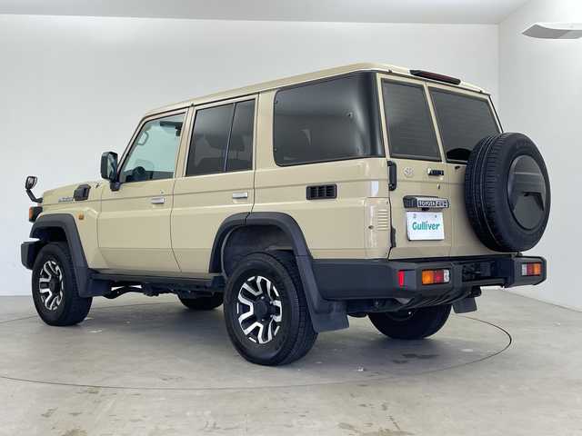 トヨタ ランドクルーザー AX 鹿児島県 2024(令6)年 2.4万km ベージュ アルパイン製ナビ/（フルセグ/Bluetooth）　/クルーズコントロール　/バックカメラ　/ＥＴＣ　/前後ドライブレコーダー　/オートハイビーム　/レーンディパーチャーアラート　/純正フロアマット　/ＬＥＤヘッドライト　/h祖い純正ＡＷ　/ダウンヒルアシストコントロール/電動格納ミラー/リモコンキー