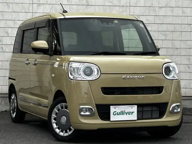 ダイハツ ムーヴ キャンバス セオリー G 大分県 2023(令5)年 0.6万km サンドベージュメタリック 純正SDナビ（NMZL-W73D）/Bluetooth/TV/CD/DVD/パワースライドドア（両側）/シートヒーター（D＋N席）/コーナーセンサー（前後）/オートブレーキホールド/アイドリングストップ/保温機能付きカップホルダー/電動格納ミラー/バックカメラ/USB・HDMI入力端子/ステアリングスイッチ/ベンチシート/スペアキー/純正フロアマット/革巻ステアリング/革巻シフトノブ/ドライブレコーダー/LED/ETC