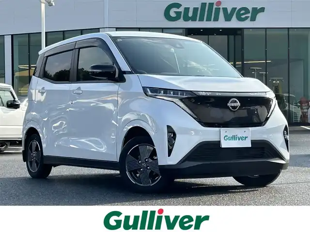 日産 サクラ G 島根県 2023(令5)年 0.4万km ホワイトパール 登録時走行距離3737km/ワンオーナー/純正ナビ(Bluetooth・AM・FM)/フルセグTV/全周囲カメラ/プロパイロット/レーダークルーズコントロール/前後コーナーセンサー/ETC2.0/シートヒーター(運転席・助手席)/ハンドルヒーター/オートライト/LEDヘッドライト/フォグランプ/純正14インチAW/純正フロアマット/スマートキー(スペアキー×1)/禁煙車