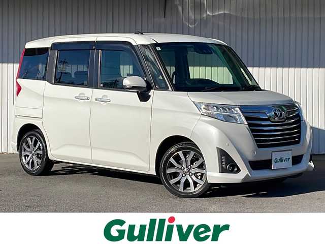 トヨタ ルーミー カスタムG－T 静岡県 2019(令1)年 2.2万km パールホワイトⅢ ９インチＳＤナビ（NSZT-Y68T）/CD/DVD/SD/Bluetooth/フルセグ/バックモニター/純正ビルトインETC/前方ドライブレコーダー/追従型クルーズコントロ―ル/レーンキープアシスト/前後コーナーセンサー/盗難防止装置/前席シートヒーター/両側パワースライドドア/純正LEDヘッドライト/フォグランプ/オートマチックハイビーム/衝突被害軽減システム/横滑り防止機能/純正15インチAW/純正ドアバイザー/純正フロアマット/取扱説明書/保証書