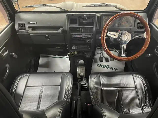 スズキ ジムニー ワイルドウィンド LTD 道央・札幌 1993(平5)年 18.3万km ダーククラシックジェイドパール 5MT/リフトアップ/マッドタイヤ/　GEOLANDAR　M/T　G003/　2025年製　9mm/前後パイプバンパー/社外マフラー（車検対応）/社外ヘッドライトレンズ/社外ウインカーレンズ（前/横）/社外フロントグリル/社外ステアリング/社外シートカバー/ナンバー移動キット/社外オーディオ/　CD/AUX/USB/FM/AM