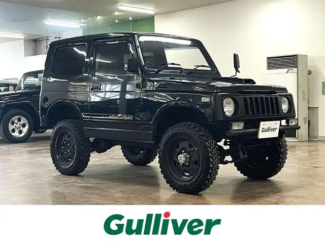 スズキ ジムニー ワイルドウィンド LTD 道央・札幌 1993(平5)年 18.3万km ダーククラシックジェイドパール 5MT/リフトアップ/マッドタイヤ/　GEOLANDAR　M/T　G003/　2025年製　9mm/前後パイプバンパー/社外マフラー（車検対応）/社外ヘッドライトレンズ/社外ウインカーレンズ（前/横）/社外フロントグリル/社外ステアリング/社外シートカバー/ナンバー移動キット/社外オーディオ/　CD/AUX/USB/FM/AM