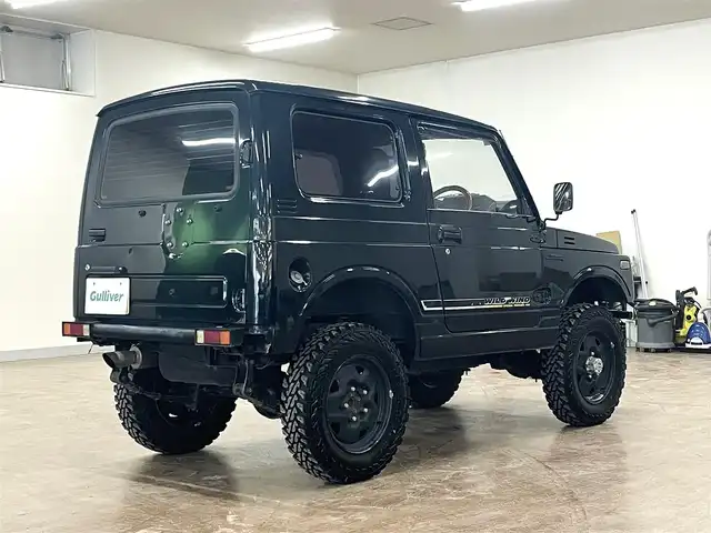 スズキ ジムニー ワイルドウィンド LTD 道央・札幌 1993(平5)年 18.3万km ダーククラシックジェイドパール 5MT/リフトアップ/マッドタイヤ/　GEOLANDAR　M/T　G003/　2025年製　9mm/前後パイプバンパー/社外マフラー（車検対応）/社外ヘッドライトレンズ/社外ウインカーレンズ（前/横）/社外フロントグリル/社外ステアリング/社外シートカバー/ナンバー移動キット/社外オーディオ/　CD/AUX/USB/FM/AM