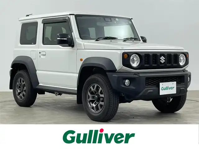 スズキ ジムニー シエラ JC 大分県 2022(令4)年 2.3万km ピュアホワイトP 純正７型ディスプレイオーディオ/(CD/DVD/BT/ipod/AUX/FM/AM)/バックカメラ/デュアルセンサーブレーキサポート/先行車発進お知らせ機能/標識認識機能/誤発進抑制機能/車線逸脱警報機能/ふらつき警報機能/ハイビームアシスト/シートヒーター/ミラーヒーター/ドラレコ前方/ビルトインETC/ステアリングリモコン/スマートキー2本/電動格納ウィンカーミラー/フォグランプ/背面タイヤカバー/マッドガード