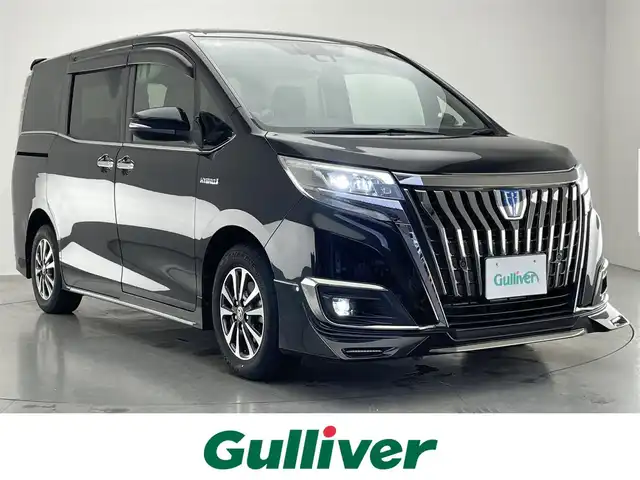 トヨタ エスクァイア ハイブリッド Gi プレミアムパッケージ ブラックテーラード 愛知県 2020(令2)年 7.6万km ブラック 純正１０型ナビ　純正１２．１型後席モニター　純正エアロ　ナビ連動前後ドラレコ　ハーフレザー　シートヒーター　ＡＣ１００Ｖ電源　バックカメラ　セーフティセンス　衝突軽減　ＬＥＤオートライト　コーナーセンサー　禁煙車