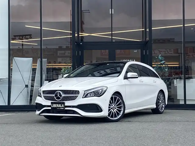 メルセデス・ベンツ ＣＬＡ１８０ Sブレイク AMG スタイル 福岡県 2018(平30)年 2.1万km ポーラホワイト ・サンルーフ/・クルーズコントロール/・純正ＨＤＤナビ／ＵＳＢ／Ｂｌｕｅｔｏｏｔｈ／ｉＰｏｄ／ＣＤ/・バックカメラ/・ハーフレザーシート／シートヒーター/・フルセグ/・ＥＴＣ/・純正１８ＡＷ/・パーキングアシスト/・アイドリングストップ/・パワーシート/・レーンキープアシスト/・オートライト/・LEDライト/・パドルシフト/・保証書/・取扱説明書