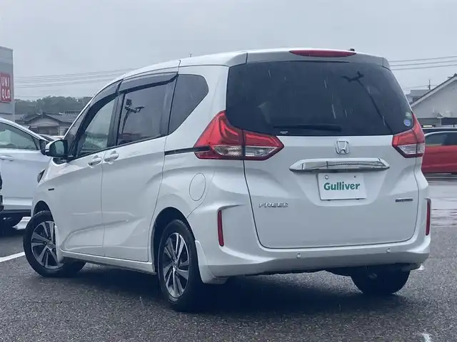ホンダ フリード ハイブリット G ホンダセンシング 島根県 2021(令3)年 7.8万km プラチナホワイトパール ワンオーナー /ディーラーOP9インチナビ(CD/DVD/BT/フルセグ)/両側パワースライドドア /衝突被害権限ブレーキ/先行車発進告知/路外逸脱抑制システム/レーンキープアシスト/標識認識/アダクティブクルーズコントロール/オートライト/LEDヘッドライト/前席シートヒーター /ビルトインETC/前後ドライブレコーダー/純正フロアマット/取扱説明書/保証書/スペアキー×1