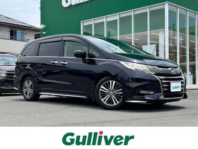 ホンダ オデッセイ アブソルート ホンダセンシング 静岡県 2017(平29)年 6.9万km 黒 エンジンスタートボタン/パワーステアリング/パワーウィンドウ/パドルシフト/アイドリングストップ/スマートキー/Wオートエアコン/クルーズコントロール追従走行/Bluetooth/CD/CDチェンジャー/USB入力端子/ETC2.0/バックカメラ/TV/メモリナビ/3列シート/オットマン/純正前方ドラレコ/ウォークスルー/純正フロアマット/D席パワーシート/布シート/両側パワースライドドア/純正サイドエアロパーツ/純正アルミホイール/ABS/横滑り防止装置/レーンキープアシスト/オートライト/W＋サイドエアバッグ/衝突軽減システム/カーテンエアバック