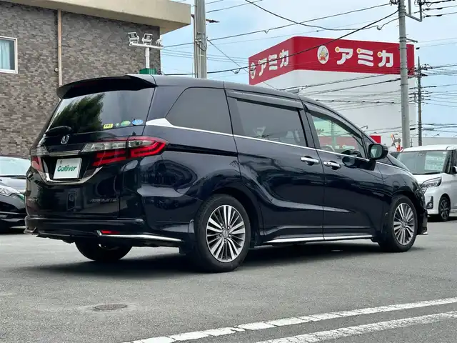 ホンダ オデッセイ アブソルート ホンダセンシング 静岡県 2017(平29)年 6.9万km 黒 エンジンスタートボタン/パワーステアリング/パワーウィンドウ/パドルシフト/アイドリングストップ/スマートキー/Wオートエアコン/クルーズコントロール追従走行/Bluetooth/CD/CDチェンジャー/USB入力端子/ETC2.0/バックカメラ/TV/メモリナビ/3列シート/オットマン/純正前方ドラレコ/ウォークスルー/純正フロアマット/D席パワーシート/布シート/両側パワースライドドア/純正サイドエアロパーツ/純正アルミホイール/ABS/横滑り防止装置/レーンキープアシスト/オートライト/W＋サイドエアバッグ/衝突軽減システム/カーテンエアバック