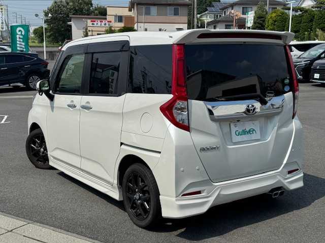 トヨタ ルーミー カスタムG－T 静岡県 2018(平30)年 5.1万km パールホワイトⅢ ●モデリスタフルエアロ/●9インチナビ/(フルセグ/CD/DVD/Bluetooth)/(ALPINE/W9Z)/●バックカメラ/●クルーズコントロール/●衝突被害軽減システム/●レーンキープアシスト/●前後コーナーセンサー/●LEDライト＆フォグランプ/●オートライト/●オートマチックハイビーム/●革巻きステアリング/●ステアリングスイッチ/●ETC/●前方ドライブレコーダー/●両側パワースライドドア/●電動格納ウィンカーミラー/●社外マフラー/●スモークフィルム/●合皮シートカバー/●社外フロアマット/●スマートキー/●プッシュスタート/●ドアバイザー/●社外15インチアルミホイール(STEINER)/●ダブルSRS＋ABS