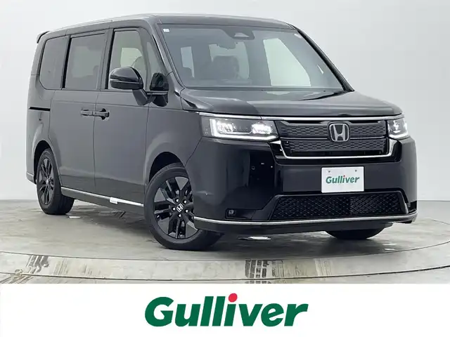 ホンダ ステップワゴン スパーダ eHEV 宮城県 2025(令7)年 0.1千km クリスタルブラックパール 登録済み未使用車/11型Honda CONNECTナビ/・BT接続/フルセグTV/・CD/DVD/・USB入力/AM/FM/15型フリップダウンモニター/安全装置/・衝突軽減ブレーキ/・踏み間違い衝突軽減システム/・ブラインドスポットモニター/・路外逸脱抑制機能/両側パワースライドドア/電動リアゲート/レーダークルーズコントロール/純正16インチAW/後列シートオットマン