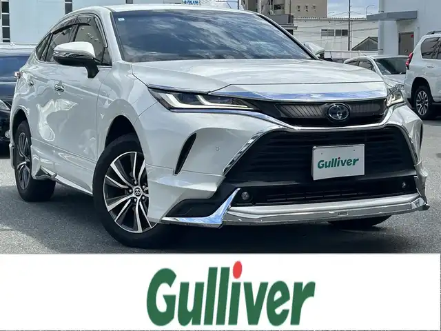 トヨタ ハリアー ハイブリッド G 福岡県 2021(令3)年 5.3万km ホワイトパールクリスタルシャイン ワンオーナー/純正メーカーナビ（フルセグTV・AM・FM・Bluetooth）/モデリスタエアロ(フロント/サイド/リア)/JBLスピーカー/電動リアゲート/ビルトインETC/レーダークルーズコントロール/コーナーセンサー（前後）/バックカメラ/ドライブセレクトモード/ドライブレコーダー（前後）/USB入力端子/ウィンカーミラー/純正18インチホイール/純正フロアマット/LEDヘッドライト/LEDフォグランプ/オートライト/オートハイビーム/ドアバイザー/プッシュスタートボタン/AACエアコン/スマートキー×２本/取扱説明書/保証書