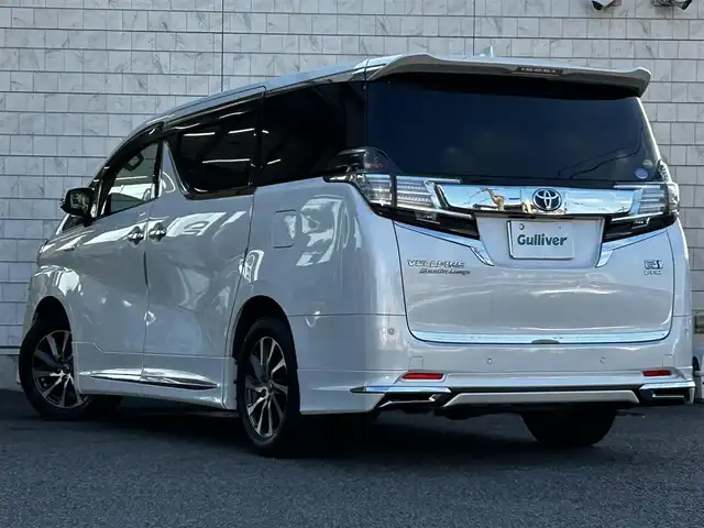 トヨタ ヴェルファイア ハイブリット エグゼクティブ ラウンジ 大分県 2015(平27)年 3.8万km ホワイトパールクリスタルシャイン ワンオーナー/JBLプレミアムサウンド/純正SDナビ/Bluetooth/フルセグ/CD/DVD/モデリスタフルエアロ/Pantneraセキュリティ/全方位カメラ/レーダークルーズコントロール/パワーシート/オットマン/シートメモリー/フリップダウンモニター/100VAC/置くだけ充電（Qi）/社外GPSレーダー/コーナーセンサー/両側パワースライドドア/パワーバックドア/USB・HDMI入力端子/純正アルミホイル17インチ/純正フロアマット/ステアリングスイッチ/ステアリングヒーター/3列シート/オートライト/オートハイビーム/ETC/ドライブレコーダー/チップアップシート/ウッドコンビハンドル/nanoe/スタットレスタイヤ/スペアキー