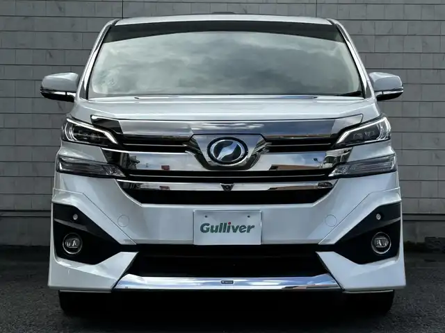 トヨタ ヴェルファイア ハイブリット エグゼクティブ ラウンジ 大分県 2015(平27)年 3.8万km ホワイトパールクリスタルシャイン ワンオーナー/JBLプレミアムサウンド/純正SDナビ/Bluetooth/フルセグ/CD/DVD/モデリスタフルエアロ/Pantneraセキュリティ/全方位カメラ/レーダークルーズコントロール/パワーシート/オットマン/シートメモリー/フリップダウンモニター/100VAC/置くだけ充電（Qi）/社外GPSレーダー/コーナーセンサー/両側パワースライドドア/パワーバックドア/USB・HDMI入力端子/純正アルミホイル17インチ/純正フロアマット/ステアリングスイッチ/ステアリングヒーター/3列シート/オートライト/オートハイビーム/ETC/ドライブレコーダー/チップアップシート/ウッドコンビハンドル/nanoe/スタットレスタイヤ/スペアキー