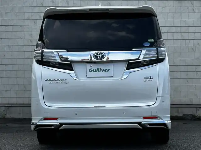 トヨタ ヴェルファイア ハイブリット エグゼクティブ ラウンジ 大分県 2015(平27)年 3.8万km ホワイトパールクリスタルシャイン ワンオーナー/JBLプレミアムサウンド/純正SDナビ/Bluetooth/フルセグ/CD/DVD/モデリスタフルエアロ/Pantneraセキュリティ/全方位カメラ/レーダークルーズコントロール/パワーシート/オットマン/シートメモリー/フリップダウンモニター/100VAC/置くだけ充電（Qi）/社外GPSレーダー/コーナーセンサー/両側パワースライドドア/パワーバックドア/USB・HDMI入力端子/純正アルミホイル17インチ/純正フロアマット/ステアリングスイッチ/ステアリングヒーター/3列シート/オートライト/オートハイビーム/ETC/ドライブレコーダー/チップアップシート/ウッドコンビハンドル/nanoe/スタットレスタイヤ/スペアキー