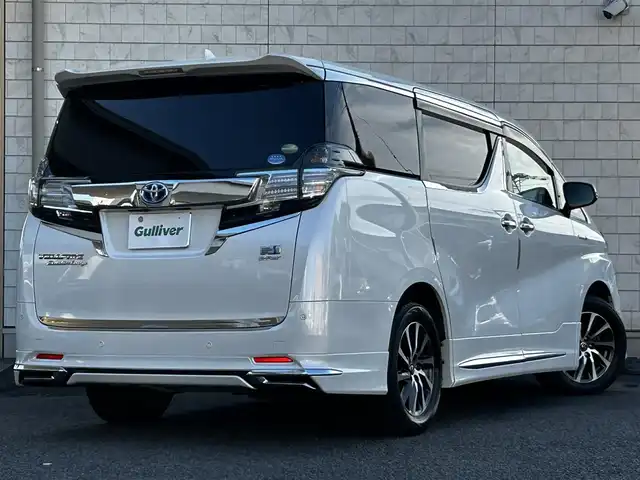 トヨタ ヴェルファイア ハイブリット エグゼクティブ ラウンジ 大分県 2015(平27)年 3.8万km ホワイトパールクリスタルシャイン ワンオーナー/JBLプレミアムサウンド/純正SDナビ/Bluetooth/フルセグ/CD/DVD/モデリスタフルエアロ/Pantneraセキュリティ/全方位カメラ/レーダークルーズコントロール/パワーシート/オットマン/シートメモリー/フリップダウンモニター/100VAC/置くだけ充電（Qi）/社外GPSレーダー/コーナーセンサー/両側パワースライドドア/パワーバックドア/USB・HDMI入力端子/純正アルミホイル17インチ/純正フロアマット/ステアリングスイッチ/ステアリングヒーター/3列シート/オートライト/オートハイビーム/ETC/ドライブレコーダー/チップアップシート/ウッドコンビハンドル/nanoe/スタットレスタイヤ/スペアキー