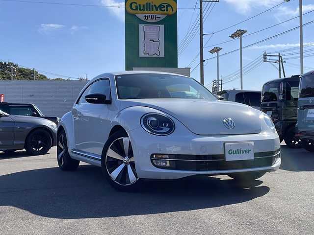 フォルクスワーゲン ザ・ビートル ターボ エクスクルーシブ 山口県 2015(平27)年 6.2万km パール フェンダーサウンド　/ドライブレコーダー　/クルーズコントロール　/レザーシート　/シートヒーター　/パーキングアシスト　/横滑り防止装置　/オートライト　/ＬＥＤヘッドライト　/ディスプレイオーディオ　　/コーナーセンサー