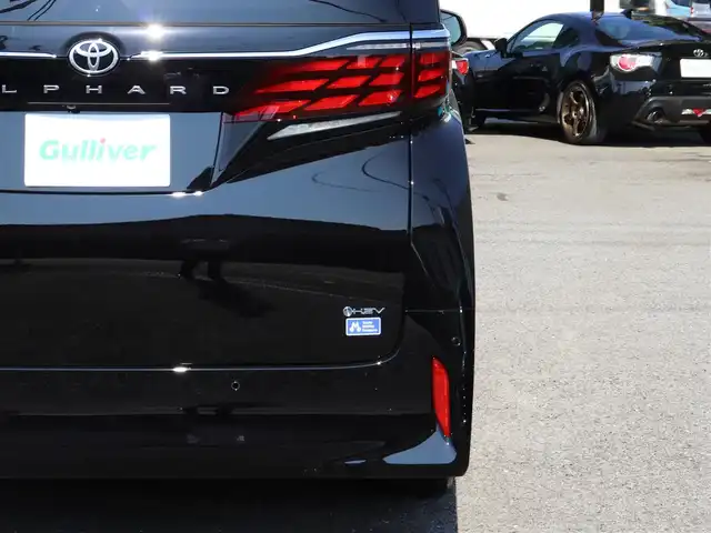 トヨタ アルファードハイブリット Z 神奈川県 2025(令7)年 0.1千km ブラック ワンオーナー/TOYOTAチームメイト/ムーンルーフ/ユニバーサルステップ/パーキングサポートブレーキ(後方歩行者)/床下透過表示機能付パラノミックビューモニター/バックカメラ洗浄機能/自動防眩インナーミラー/ステアリングヒーター/排気ガス検知式フルオートエアコン/マイコンプリセットドライビングポジションシステム/助手席肩口パワーシートスイッチ/2列目エグゼクティブシート/14インチディスプレイオーディオ/10スピーカー/JBLサウンドスピーカー/アドバンストパーク/パーキングサポートシステム/アドバントドライブ/フロントクロストラフィックアラート/レーンチェンジアシスト/ドライバーモニターカメラ/パドルシフト/エレクトロシフトマチック/保証書/スペアスマートキー/純正メモリナビ/フルセグテレビ/アラウンドビューモニター/ウィンカーミラー/オットマン/アダクティブアクティブクルーズコントロール/ドアバイザー/プッシュスタート/両側パワースライドドア/パワーバックドア/ETC2.0/デジタルインナーミラー/置くだけ充電/100V電源