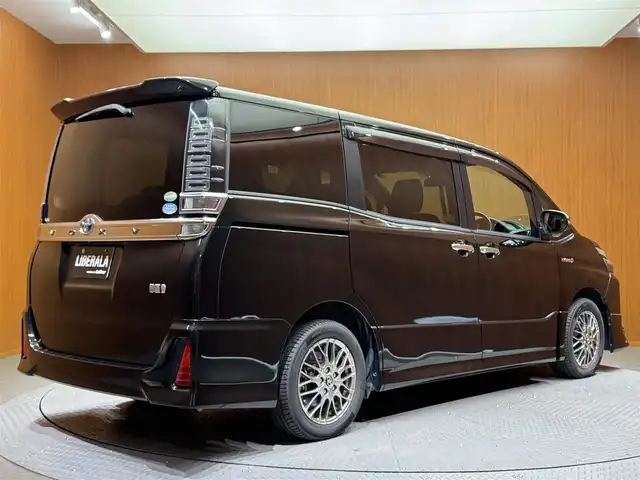 トヨタ ヴォクシー ハイブリッド ZS 煌 千葉県 2018(平30)年 15.7万km イナズマスパーキングブラックガラスフレーク ワンオーナー/純正SDナビ(NSZN-Z66T)/純正フリップダウンモニター(V12T-R66C)/フルセグテレビ/Bluetooth接続/CD/DVD/SD再生/バックカメラ/ビルトインETC2.0/クルーズコントロール/純正ドライブレコーダー/前席シートヒーター/プリクラッシュセーフティ/レーンディパーチャーアラート/先行車発進告知/電動格納ウィンカーミラー/フロントフォグ/オートマチックハイビーム/モデリスタエアロ/ドアバイザー/純正16インチアルミホイール/保証書/取扱説明書