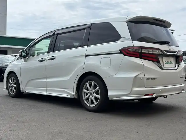ホンダ オデッセイ アブソルート・EXホンダセンジング 東京都 2018(平30)年 9.9万km プラチナホワイトパール 純正ナビ/６スピーカー/ホンダセンシング/マルチビューモニター/ホンダスマートパーキングアシストシステム/パーキングセンサーシステム/ブラインドスポットインフォメーション/アウターウエルカムライト付両側パワースライドドア/LEDヘッドランプ/オートライト/LEDアクティブコーナリングライト/コンフォートビューパッケージ（親水/ヒーテッドドアミラー/フロントドア撥水ガラス）/レッド照明アナログメーター/マルチインフォメーションディスプレイ/革巻きステアリングホイール/ステアリングスイッチ/パドルシフト/SRSエアバック （運転席/助手席）/プラズマクラスター付左右独立温度調整オートエアコン/リアオートエアコン/ブラックプライムスムース（合皮）/ファブリックコンビシート/パワーシート/シートヒーター/大型アームレスト（運転席/助手席）/センターコンソール/２列目プレミアムグレードルシート（オットマン /小物入/左右アームレスト付キャプテンシート）/リヤモニター/アダプティブクルーズコントロール　/車線維持支援システム