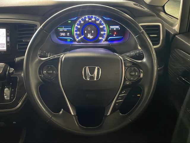 ホンダ オデッセイ ハイブリッド アブソルート・EXホンダセンジング 広島県 2017(平29)年 5.7万km モダンスティールM 禁煙車/純正ナビ/バックカメラ/両側パワースライドドア/ブラインドスポットモニター/1500W給電/レーダークルーズコントロール/ＥＴＣ/オットマン/オートライト/VENERDI18インチアルミホイール(225/45/R18)/衝突被害軽減/レーンキープアシスト/フォグランプ/エアバッグ(運転席/助手席/サイド/カーテン)