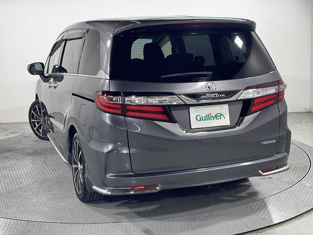 ホンダ オデッセイ ハイブリッド アブソルート・EXホンダセンジング 広島県 2017(平29)年 5.7万km モダンスティールM 禁煙車/純正ナビ/バックカメラ/両側パワースライドドア/ブラインドスポットモニター/1500W給電/レーダークルーズコントロール/ＥＴＣ/オットマン/オートライト/VENERDI18インチアルミホイール(225/45/R18)/衝突被害軽減/レーンキープアシスト/フォグランプ/エアバッグ(運転席/助手席/サイド/カーテン)