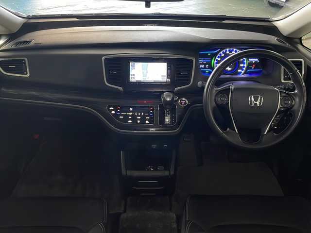 ホンダ オデッセイ ハイブリッド アブソルート・EXホンダセンジング 広島県 2017(平29)年 5.7万km モダンスティールM 禁煙車/純正ナビ/バックカメラ/両側パワースライドドア/ブラインドスポットモニター/1500W給電/レーダークルーズコントロール/ＥＴＣ/オットマン/オートライト/VENERDI18インチアルミホイール(225/45/R18)/衝突被害軽減/レーンキープアシスト/フォグランプ/エアバッグ(運転席/助手席/サイド/カーテン)