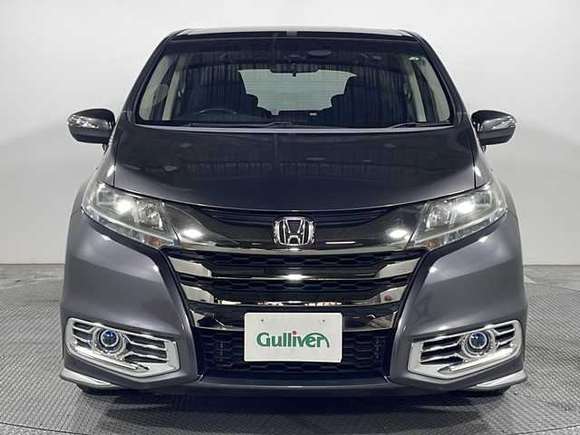 ホンダ オデッセイ ハイブリッド アブソルート・EXホンダセンジング 広島県 2017(平29)年 5.7万km モダンスティールM 禁煙車/純正ナビ/バックカメラ/両側パワースライドドア/ブラインドスポットモニター/1500W給電/レーダークルーズコントロール/ＥＴＣ/オットマン/オートライト/VENERDI18インチアルミホイール(225/45/R18)/衝突被害軽減/レーンキープアシスト/フォグランプ/エアバッグ(運転席/助手席/サイド/カーテン)