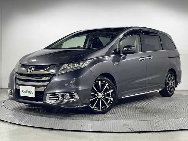 ホンダ オデッセイ ハイブリッド アブソルート・EXホンダセンジング 広島県 2017(平29)年 5.7万km モダンスティールM 禁煙車/純正ナビ/バックカメラ/両側パワースライドドア/ブラインドスポットモニター/1500W給電/レーダークルーズコントロール/ＥＴＣ/オットマン/オートライト/VENERDI18インチアルミホイール(225/45/R18)/衝突被害軽減/レーンキープアシスト/フォグランプ/エアバッグ(運転席/助手席/サイド/カーテン)