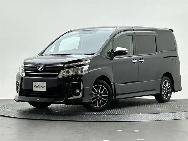 トヨタ ヴォクシー ZS 煌 愛媛県 2015(平27)年 9.1万km ブラック 社外ディスプレイオーディオ　/バックカメラ　/前方ドラレコ　/純正ETC　/両側パワースライドドア/社外シフトノブ　/社外コンソール　/LEDライト　/スペアキー/純正アルミホイール
