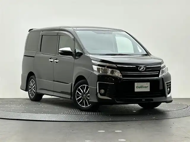 トヨタ ヴォクシー ZS 煌 愛媛県 2015(平27)年 9.1万km ブラック 社外ディスプレイオーディオ　/バックカメラ　/前方ドラレコ　/純正ETC　/両側パワースライドドア/社外シフトノブ　/社外コンソール　/LEDライト　/スペアキー/純正アルミホイール