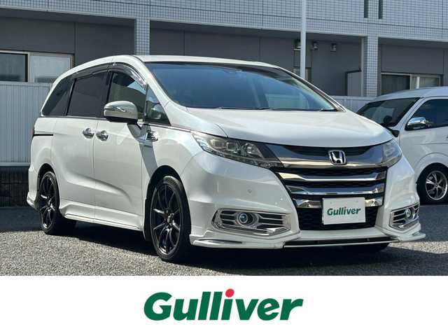 ホンダ オデッセイ ハイブリッド アブソルートセンシングEXパック 愛知県 2016(平28)年 10.5万km ホワイトオーキッドパール 純正8インチディーラーオプションナビ(FM/AM/CD/DVD/USB/BT/iPod/HDMI/フルセグ)/フリップダウンモニター/ホンダセンシング/衝突軽減ブレーキ/路外逸脱抑制機能/アダクティブクルーズコントロール/車両接近通報装置/ブラインドスポットモニター/クリアランスソナー・コーナーセンサー/バックカメラ/ハーフレザー/パワーシート/両側パワースライドドア/ドライブレコーダー/HIDヘッドライト/電動格納ミラー/社外AW18インチ/純正フロアマット/ETC/プッシュスタート/スマートキー・スペアキー１本/ABS/取扱説明書・保証書