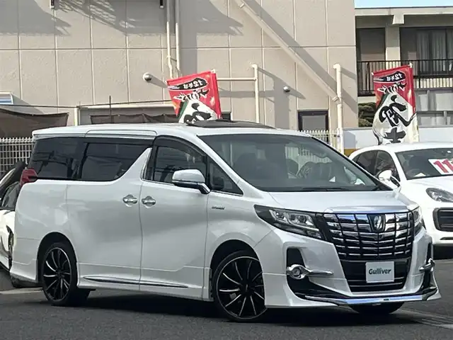 トヨタ アルファードハイブリット SR 新潟県 2016(平28)年 9万km ホワイトパールクリスタルシャイン /禁煙車//ワンオーナー//モデリスタフルエアロ//マフラーカッター//ALPINE11インチナビ//AM/FM/CD/DVD/SD/HDMI/USB/AUX//フルセグTV//バックカメラ//サイドカメラ//ビルトインETC//ALPINEフリップダウンモニター//PCS/ACC/TRC/クリソナ//インテリジェントクリアランスソナー//両側パワースライドドア//オートLEDライト//フォグランプ//ハーフレザーシート//前席パワーシート//D席シートメモリー//オートリトラクタブルウィンカーミラー//ウッドコンビステアリング//ステアリングリモコン//電動パーキングブレーキ//オートホールド//パワーバックドア//EV/ECO MODE//オットマン//ロールサンシェード//nanoe//純正AW付スタッドレスタイヤ積込//プッシュスタート//スマートキー//スペアキー//純正フロアマット//純正ドアバイザー//保証書//取扱説明書//ナビ取扱説明書//H28-30年ディーラー記録簿